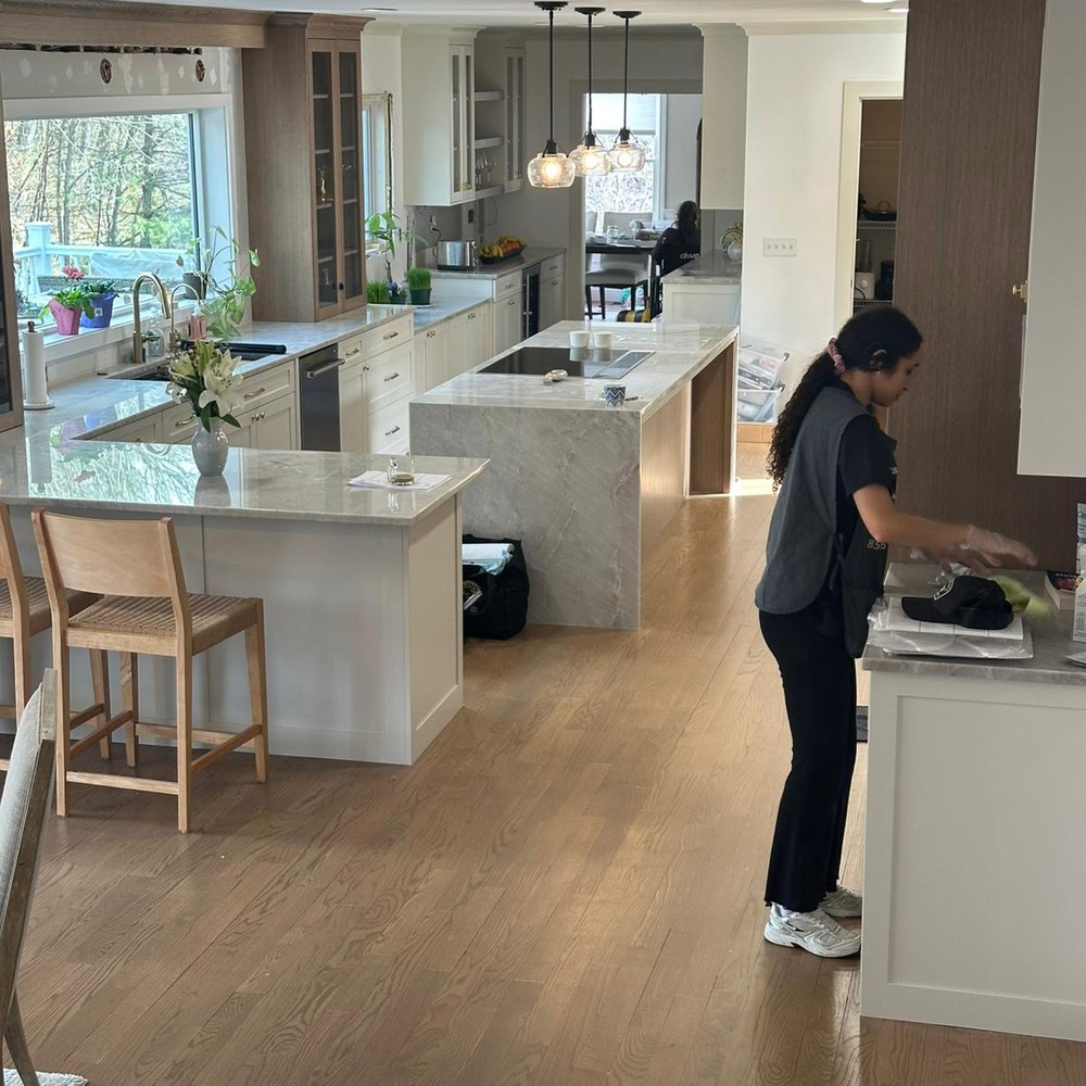 Allegry Cleaning Services professional cleaning a bright, upscale open-concept kitchen in Metro Boston