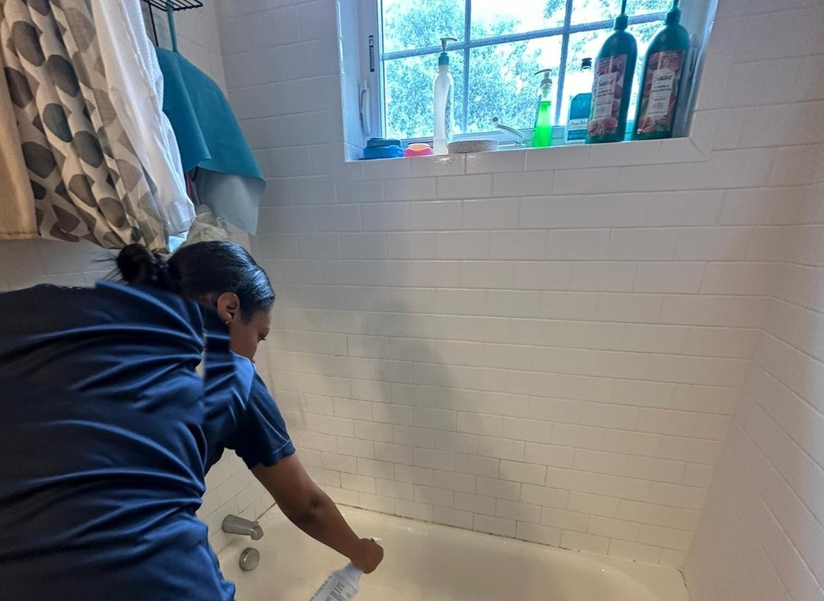 Allegry cleaner scrubbing and detailing a bathtub during a professional cleaning in Metro Boston